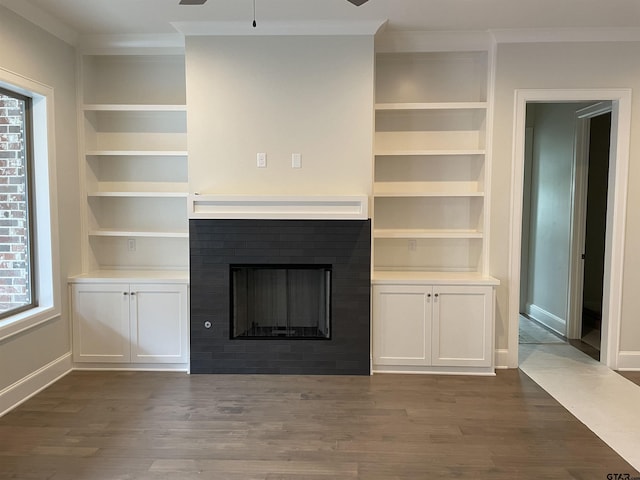 unfurnished living room with ornamental molding, dark wood-type flooring, and ceiling fan