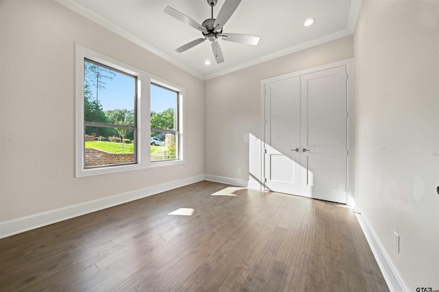 spare room featuring crown molding, ceiling fan, and dark hardwood / wood-style flooring