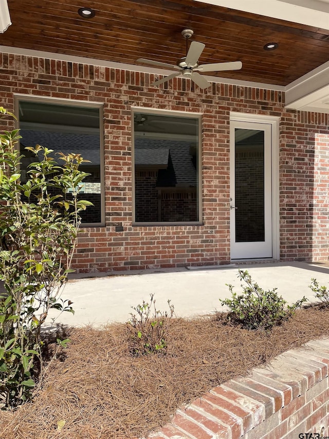 property entrance with a patio area and ceiling fan