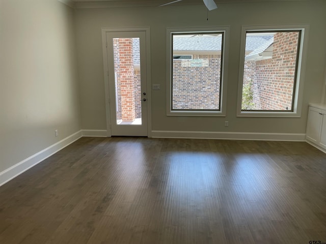 unfurnished room featuring a healthy amount of sunlight and dark hardwood / wood-style floors