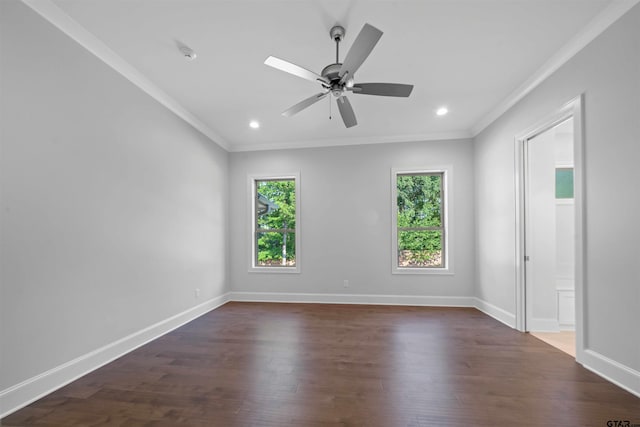 empty room featuring dark hardwood / wood-style flooring, crown molding, and ceiling fan