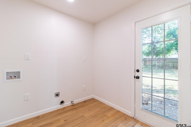 laundry room featuring hookup for an electric dryer, light hardwood / wood-style floors, gas dryer hookup, and washer hookup