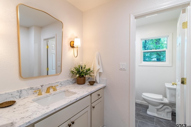 bathroom featuring vanity and toilet