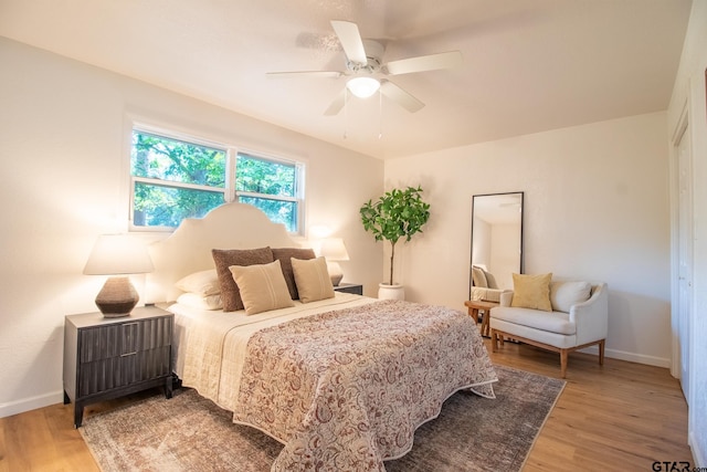 bedroom featuring hardwood / wood-style floors and ceiling fan