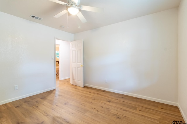 spare room featuring ceiling fan and light hardwood / wood-style floors