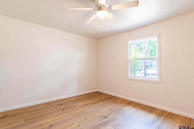 empty room with light hardwood / wood-style floors and ceiling fan