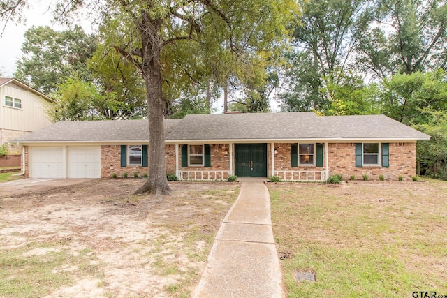 single story home with a front yard, a porch, and a garage