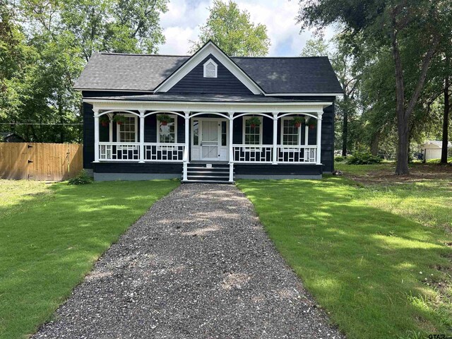 605 E Calvert St, Troup, TX 75789 - view of front of property featuring a porch and a shingled roof