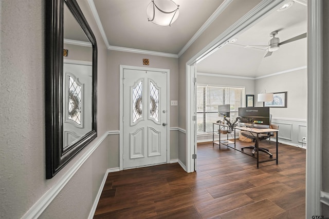 entrance foyer featuring ceiling fan, ornamental molding, wainscoting, dark wood-style floors, and a decorative wall