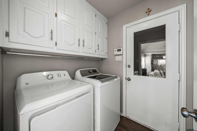 washroom with cabinet space, dark wood-style floors, and washing machine and clothes dryer