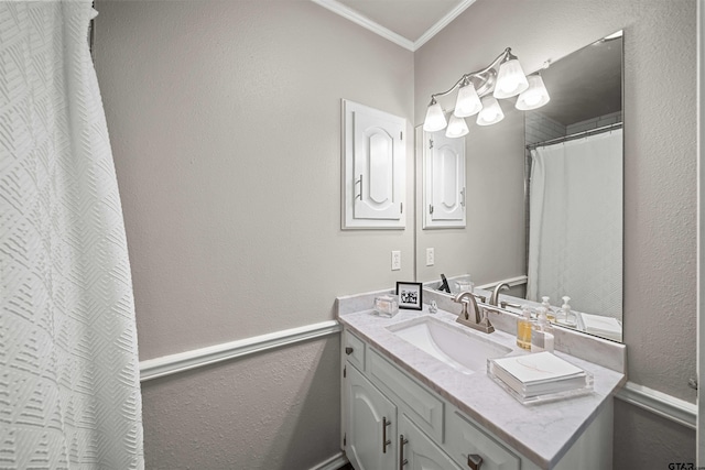 full bathroom featuring ornamental molding, vanity, and a textured wall