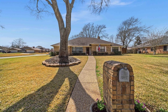 view of front of home featuring a chimney and a front yard