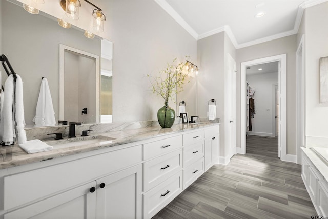 bathroom with hardwood / wood-style flooring, ornamental molding, and vanity