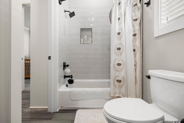 bathroom featuring shower / bath combo, wood-type flooring, and toilet