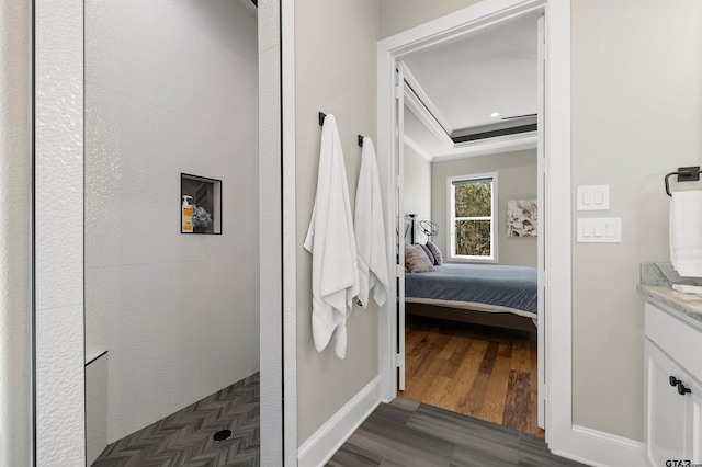 bathroom with hardwood / wood-style flooring, vanity, and walk in shower