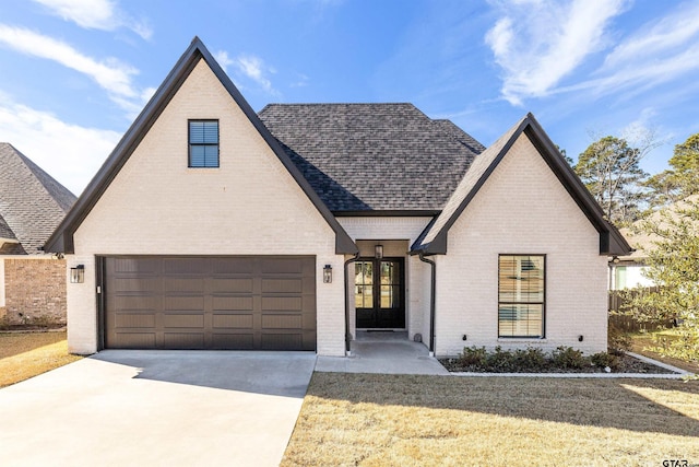 view of front of house with a garage and french doors