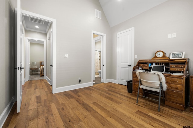 home office with high vaulted ceiling and light hardwood / wood-style floors