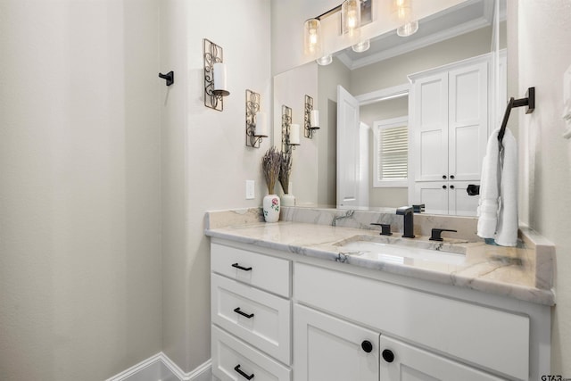 bathroom with crown molding and vanity