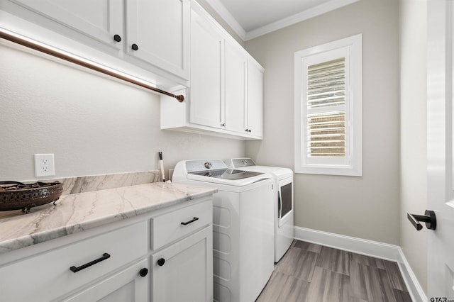 washroom featuring cabinets, independent washer and dryer, ornamental molding, and light wood-type flooring