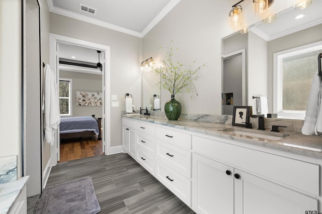 bathroom featuring vanity, hardwood / wood-style floors, and crown molding