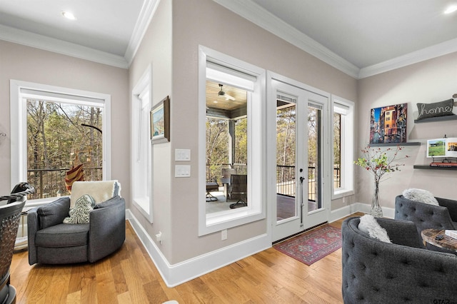 doorway to outside with hardwood / wood-style floors and crown molding