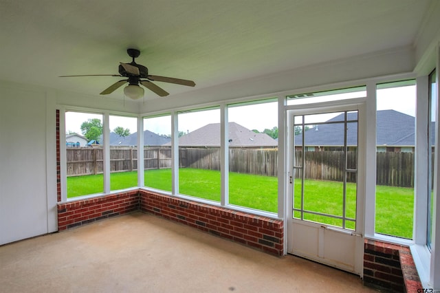 unfurnished sunroom featuring a ceiling fan