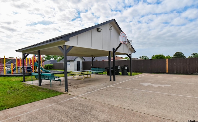 exterior space featuring an outdoor structure, fence, a shed, and playground community