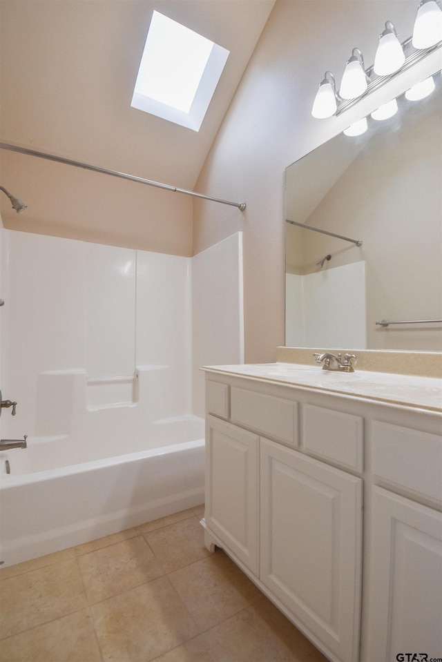 full bath featuring lofted ceiling with skylight, shower / bathing tub combination, tile patterned flooring, and vanity