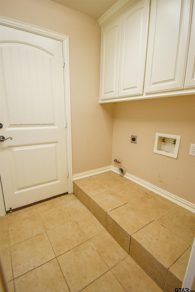 washroom featuring hookup for a washing machine, gas dryer hookup, cabinet space, light tile patterned floors, and hookup for an electric dryer