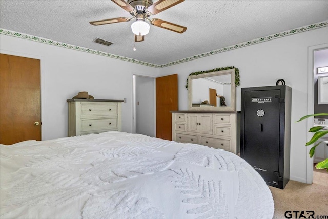 412 Peach Tree Dr, Palestine, TX 75803 - bedroom featuring light colored carpet, a textured ceiling, and a ceiling fan