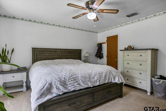 412 Peach Tree Dr, Palestine, TX 75803 - carpeted bedroom featuring a textured ceiling and a ceiling fan