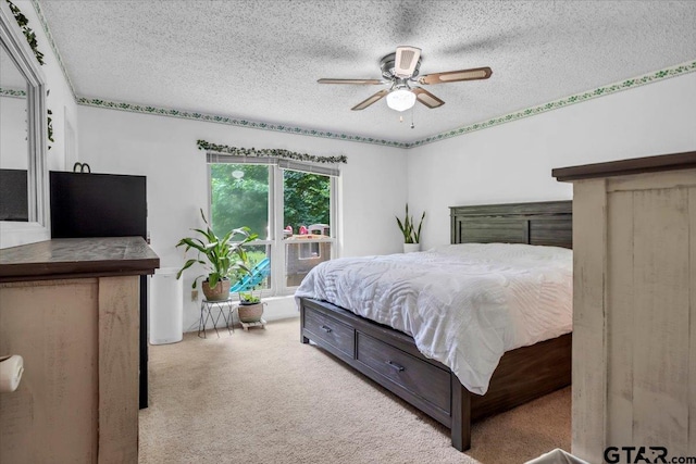 412 Peach Tree Dr, Palestine, TX 75803 - carpeted bedroom featuring a textured ceiling and a ceiling fan