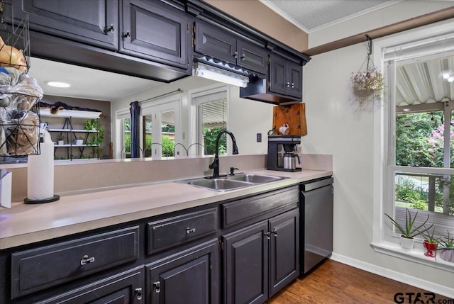 412 Peach Tree Dr, Palestine, TX 75803 - kitchen with dishwasher, light countertops, ornamental molding, and dark wood-style floors