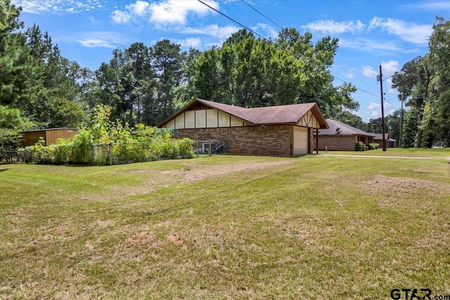412 Peach Tree Dr, Palestine, TX 75803 - view of property exterior with an attached garage and a yard