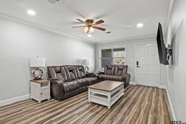 living room with crown molding, dark hardwood / wood-style flooring, and ceiling fan