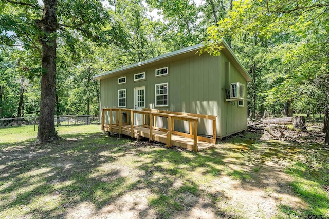 14677 County Road 2337, Tyler, TX 75707 - rear view of house featuring fence, a wooden deck, a cooling unit, and view of wooded area