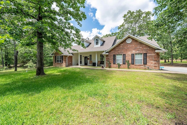 14677 County Road 2337, Tyler, TX 75707 - cape cod house with brick siding, a front yard, and a shingled roof