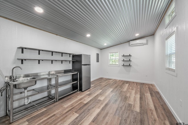 14677 County Road 2337, Tyler, TX 75707 - office area with a sink, light wood-type flooring, an AC wall unit, wooden ceiling, and lofted ceiling