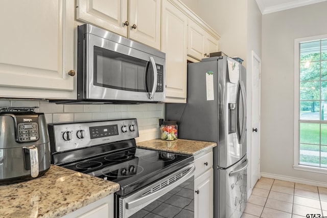 14677 County Road 2337, Tyler, TX 75707 - kitchen featuring appliances with stainless steel finishes, crown molding, tasteful backsplash, healthy amount of natural light, and baseboards