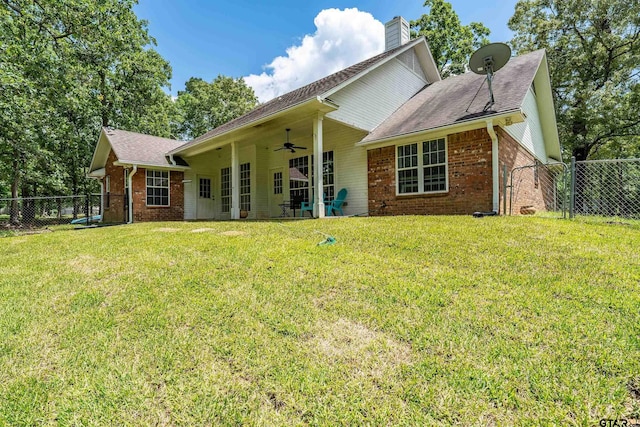 14677 County Road 2337, Tyler, TX 75707 - back of house with brick siding, a ceiling fan, a chimney, and roof with shingles