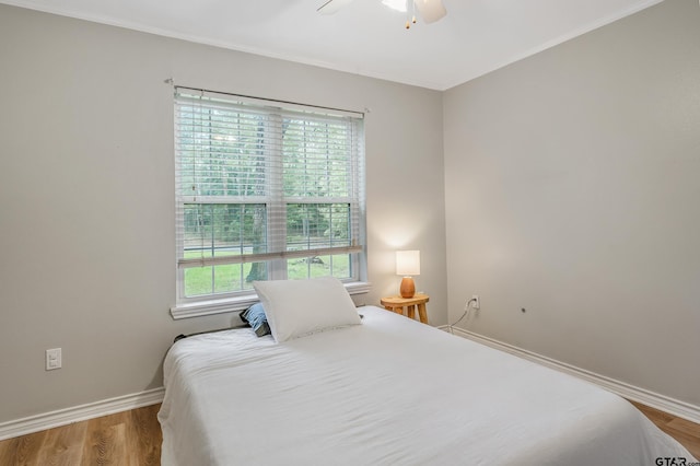 14677 County Road 2337, Tyler, TX 75707 - bedroom featuring multiple windows, baseboards, wood finished floors, ornamental molding, and a ceiling fan