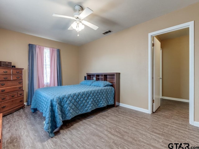 bedroom with ceiling fan and hardwood / wood-style floors