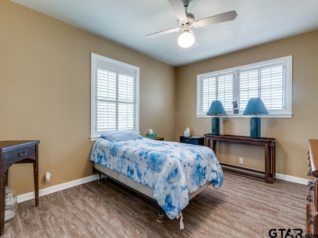 bedroom featuring wood-type flooring and ceiling fan