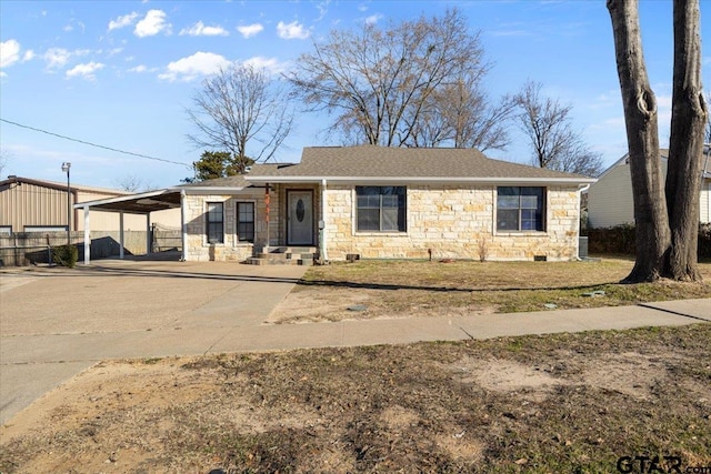 single story home featuring a carport and a front yard