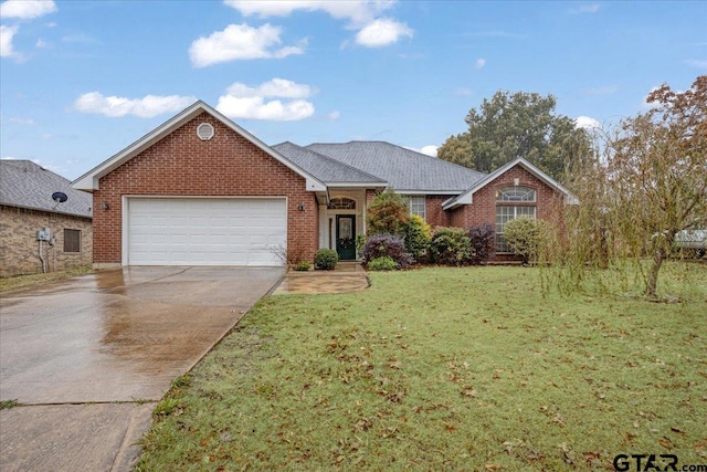 view of front of house with a garage and a front lawn