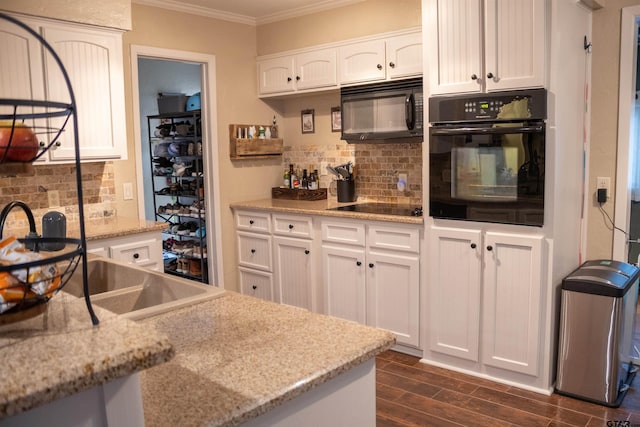 kitchen featuring black appliances, light stone countertops, dark hardwood / wood-style floors, and white cabinets