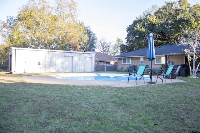 view of pool featuring an outdoor structure, a patio, and a yard