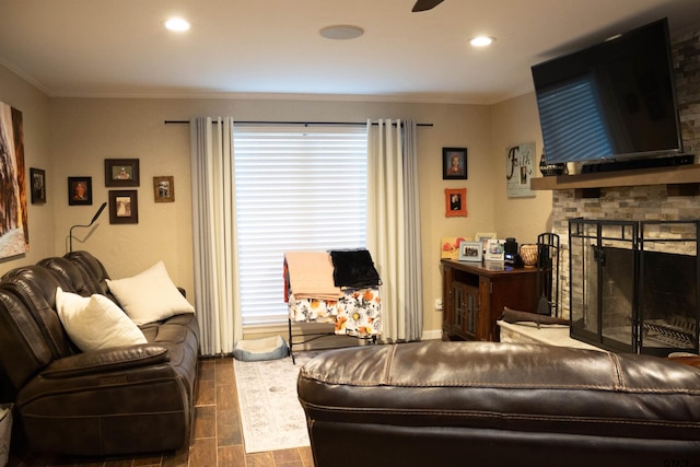 living room with a fireplace and crown molding