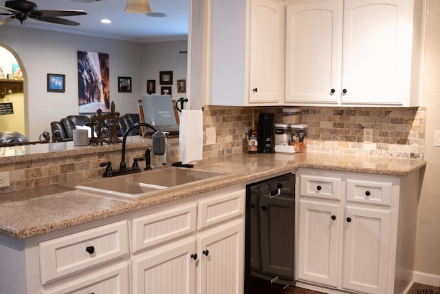 kitchen with sink, ceiling fan, backsplash, white cabinets, and black dishwasher