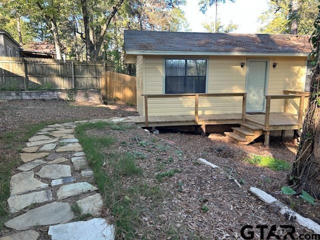 exterior space featuring fence and a wooden deck